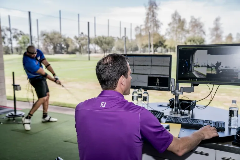An image of a physiotherapist working with a golfer.